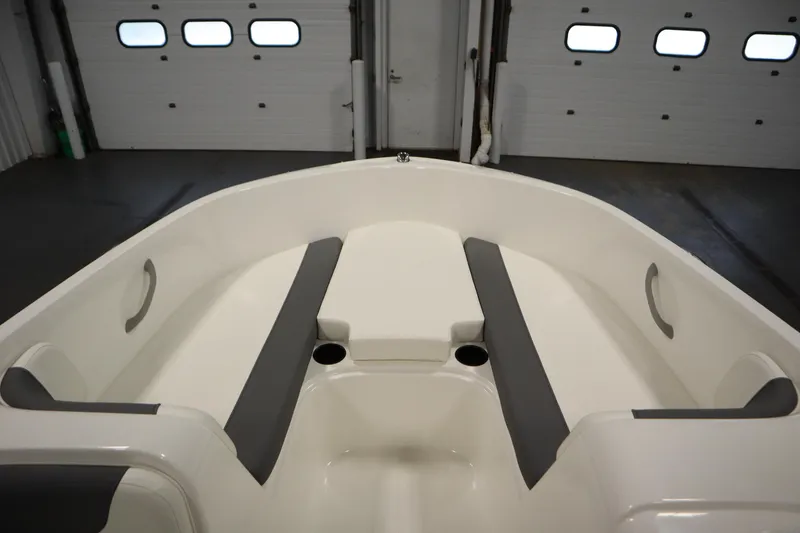 Slide: The Image of 2026 Bayliner Element E18 boat interior with gray seating and cup holders. - 10