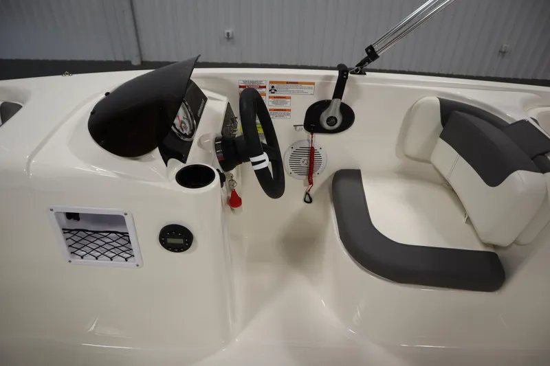 Slide: The Image of 2026 Bayliner Element E18 boat interior with steering wheel and seating. - 14