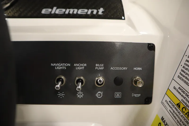 Slide: The Image of Control panel of 2026 Bayliner Element E18 boat with switches for lights and horn. - 18