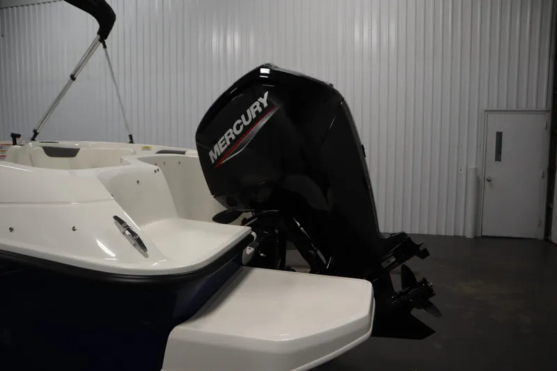 Slide: The Image of 2026 Bayliner Element E18 with Mercury outboard motor in a garage setting. - 29