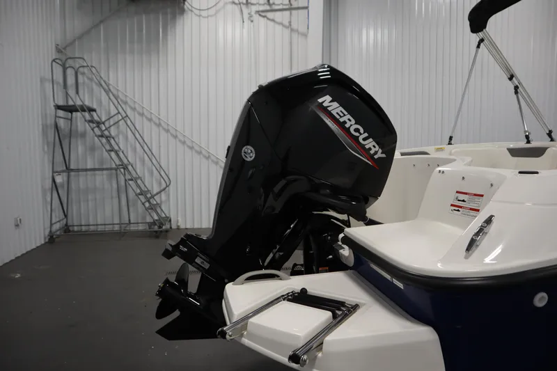 Slide: The Image of 2026 Bayliner Element E18 boat with Mercury outboard motor in a storage facility. - 30