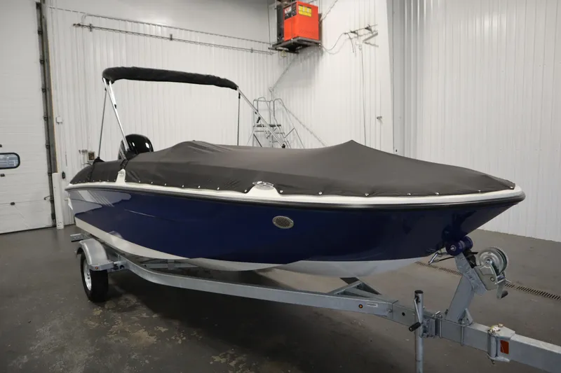 Slide: The Image of 2026 Bayliner Element E18 boat with cover on trailer in indoor storage. - 35