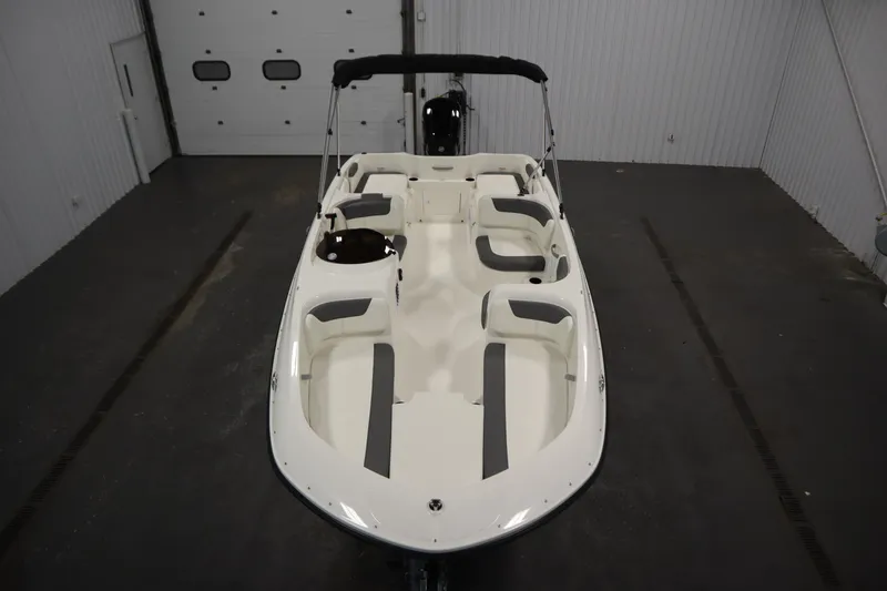 Slide: The Image of 2026 Bayliner Element E18 boat in indoor storage, showcasing spacious seating and sleek design. - 8