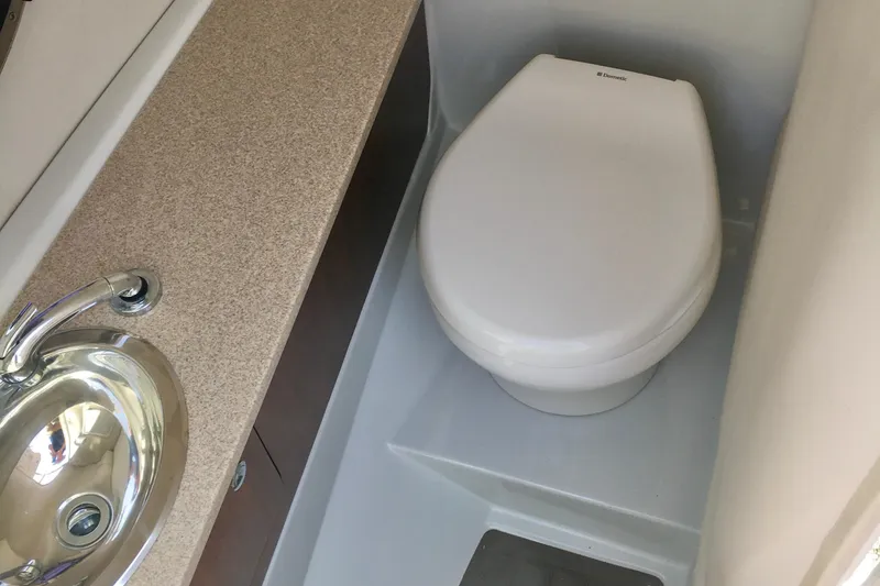 Slide: The Image of 2017 Crownline 275 SS boat bathroom with sink and toilet. - 12