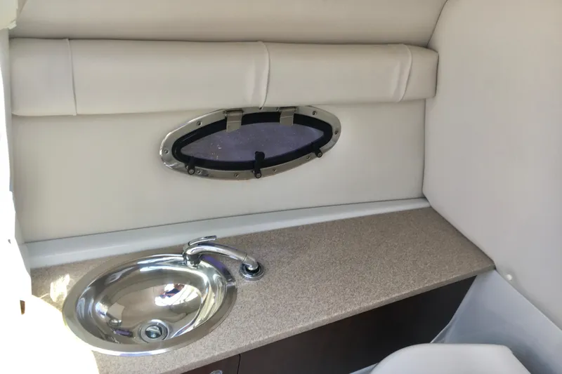 Slide: The Image of Interior of 2017 Crownline 275 SS boat with sink and porthole window. - 13