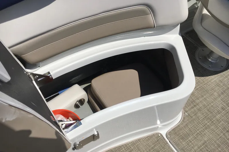 Slide: The Image of 2017 Crownline 275 SS boat interior storage compartment with beige seating and carpeted flooring. - 14