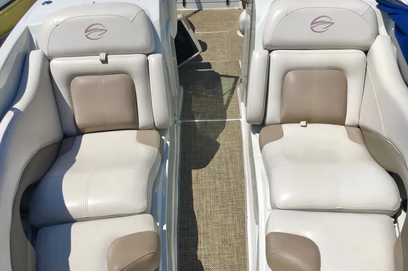Slide: The Image of 2017 Crownline 275 SS boat interior with beige and white cushioned seating. - 17