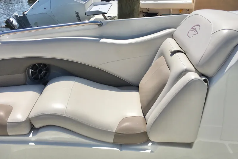 Slide: The Image of 2017 Crownline 275 SS boat interior with beige leather seating and speaker. - 19