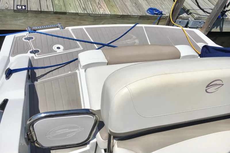 Slide: The Image of 2017 Crownline 275 SS boat interior with seating and deck, docked with ropes. - 21