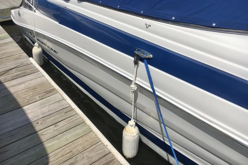 Slide: The Image of 2017 Crownline 275 SS boat docked with blue and white exterior. - 4