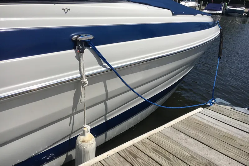 Slide: The Image of 2017 Crownline 275 SS boat docked with blue and white exterior. - 5