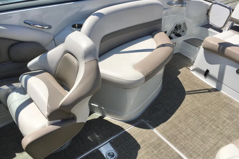 Slide: The Image of 2017 Crownline 275 SS boat interior with beige and white seating, carpeted floor. - 8