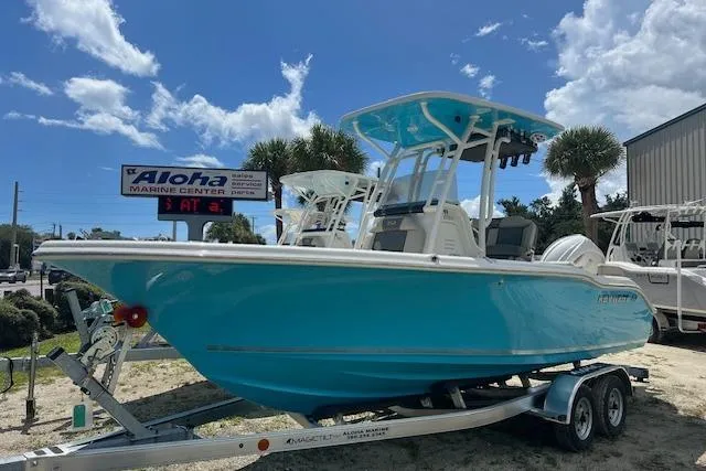 The Image of 2026 Key West 219 FS boat on trailer at Aloha Marine Center, under a sunny sky. - 0