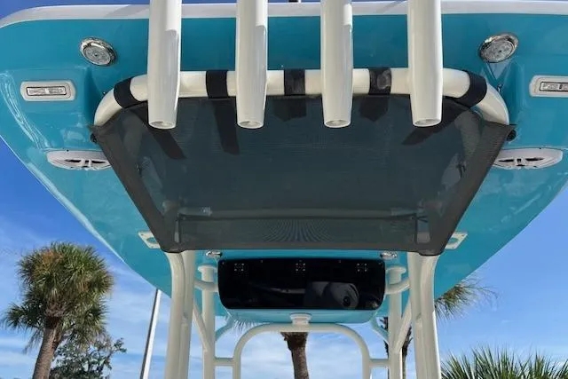 Slide: The Image of 2026 Key West 219 FS boat with blue hull and rod holders, viewed from below. - 4