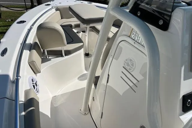 Slide: The Image of 2026 Key West 219 FS boat interior with seating and table setup. - 7
