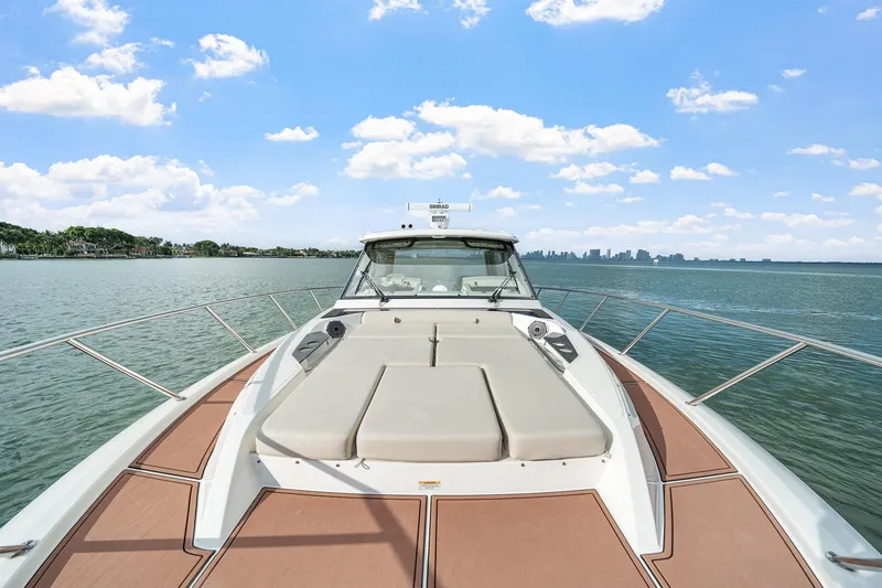 Slide: The Image of 2024 Boston Whaler 405 Conquest boat on calm water under blue sky. - 10