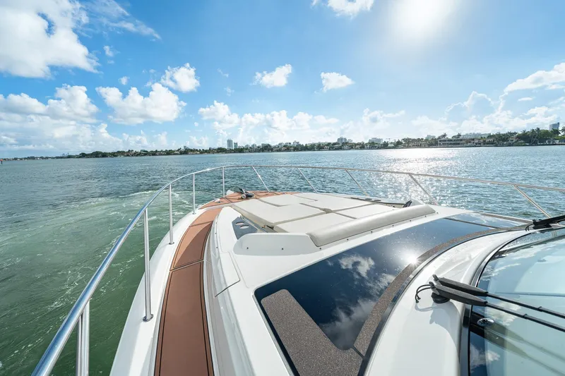 Slide: The Image of 2024 Boston Whaler 405 Conquest cruising on a sunny day, showcasing sleek design and open waters. - 14