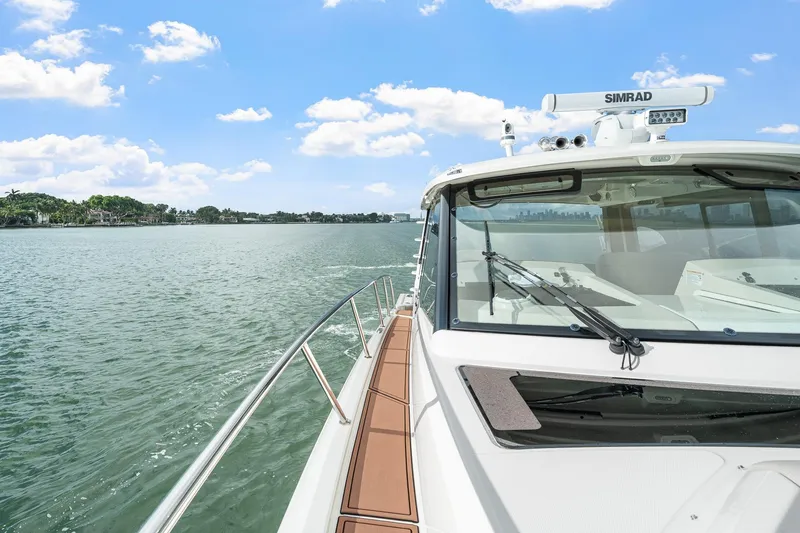 Slide: The Image of 2024 Boston Whaler 405 Conquest cruising on a sunny day, showcasing sleek design and advanced features. - 15