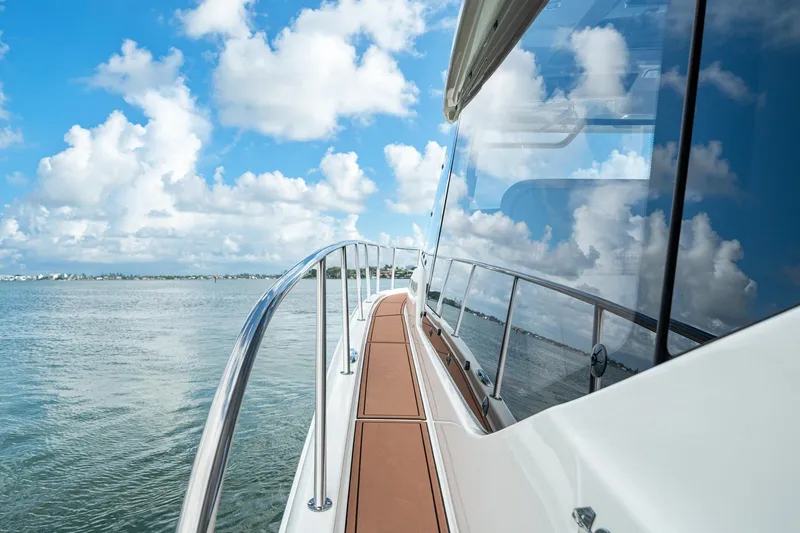 Slide: The Image of 2024 Boston Whaler 405 Conquest yacht on calm waters under a blue sky. - 17