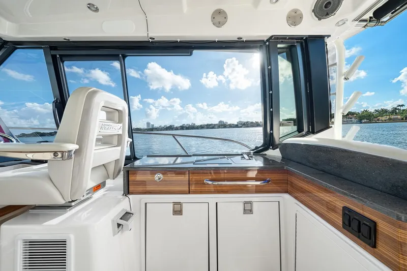 Slide: The Image of 2024 Boston Whaler 405 Conquest interior with scenic water view through windows. - 21