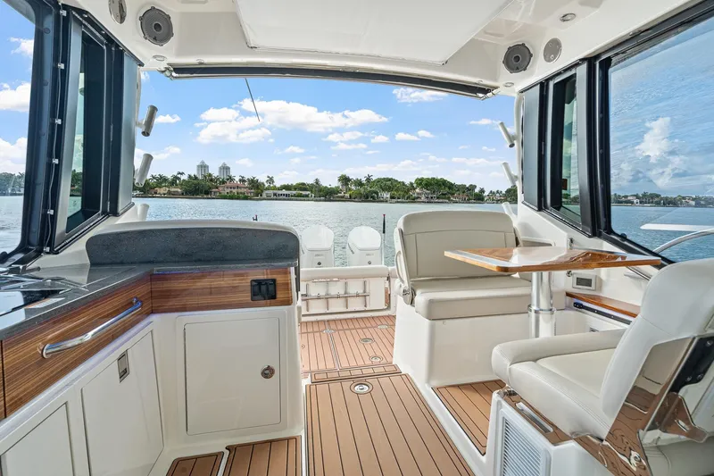 Slide: The Image of 2024 Boston Whaler 405 Conquest interior with luxurious seating and scenic water view. - 22