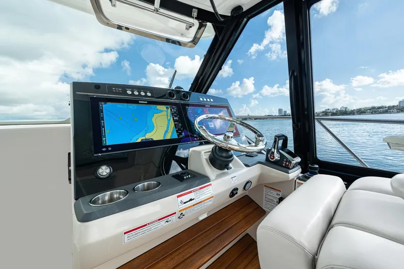 Slide: The Image of 2024 Boston Whaler 405 Conquest helm with advanced navigation displays and luxurious seating. - 26