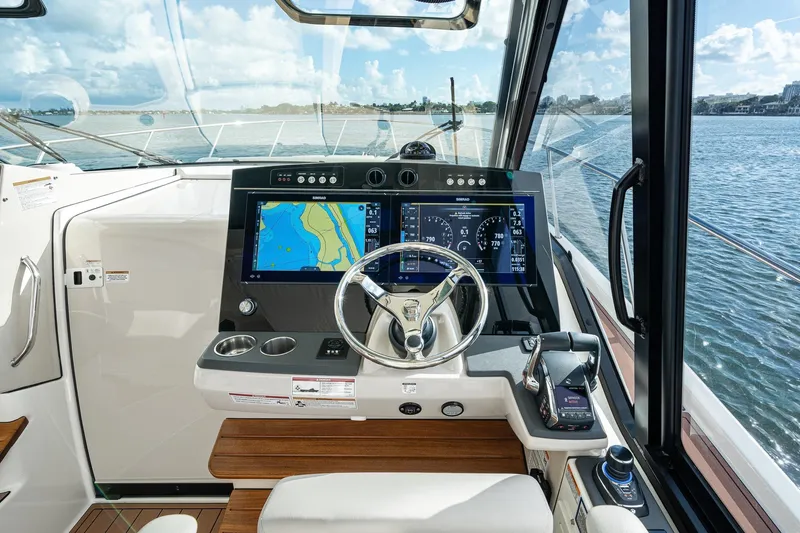 Slide: The Image of 2024 Boston Whaler 405 Conquest helm with advanced navigation displays and controls. - 31