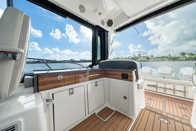 Slide: The Image of 2024 Boston Whaler 405 Conquest interior with sleek design and waterfront view. - 32