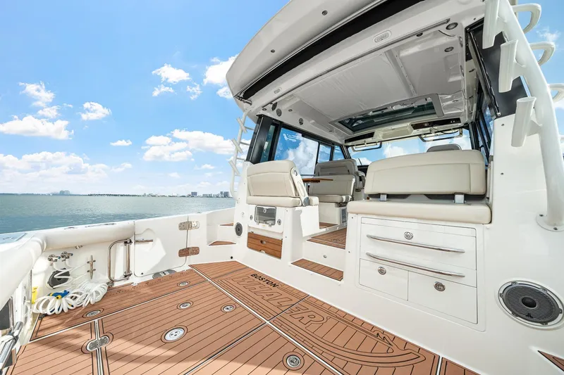 Slide: The Image of 2024 Boston Whaler 405 Conquest boat interior with luxurious seating and ocean view. - 33
