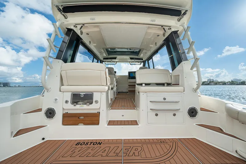 Slide: The Image of 2024 Boston Whaler 405 Conquest boat interior with luxurious seating and ocean view. - 34