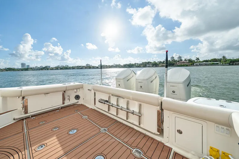 Slide: The Image of 2024 Boston Whaler 405 Conquest boat deck with Mercury engines on a sunny day. - 36