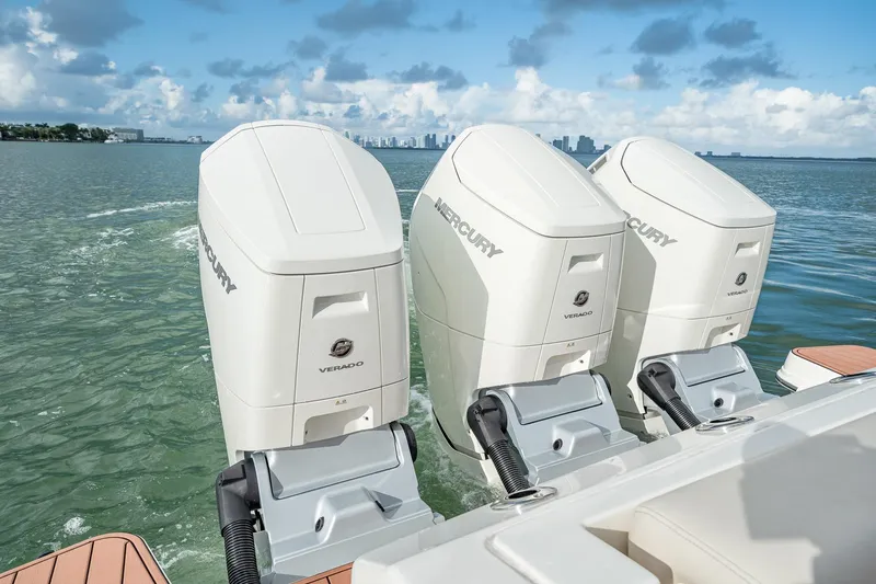 Slide: The Image of Triple Mercury Verado engines on a 2024 Boston Whaler 405 Conquest, cruising on open water. - 40