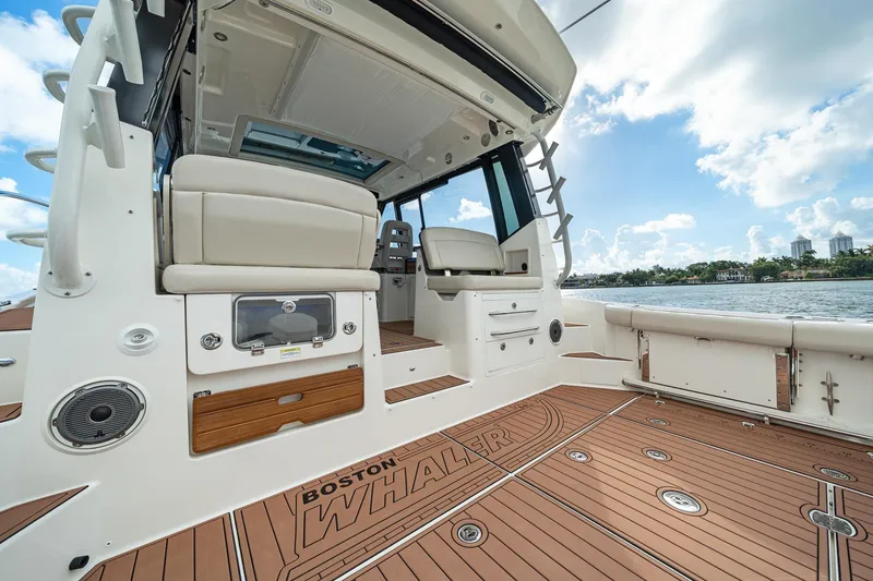 Slide: The Image of 2024 Boston Whaler 405 Conquest boat interior with seating and deck view. - 41