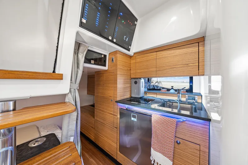 Slide: The Image of Luxurious interior of 2024 Boston Whaler 405 Conquest yacht with modern kitchen amenities. - 45