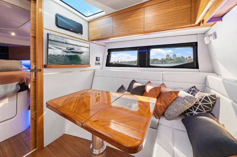 Slide: The Image of Luxurious interior of 2024 Boston Whaler 405 Conquest with elegant wood finishes and plush seating. - 49