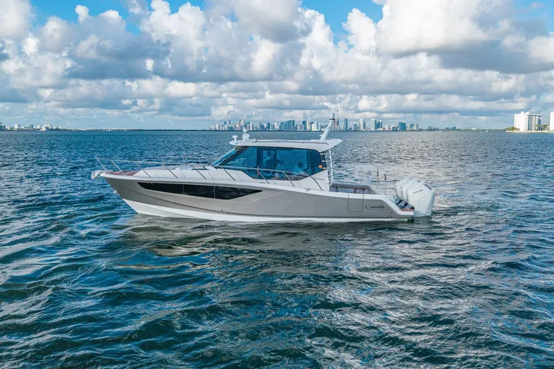Slide: The Image of 2024 Boston Whaler 405 Conquest cruising on open water under a cloudy sky. - 55