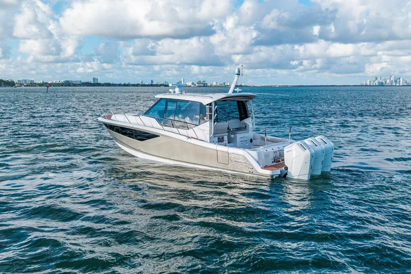 Slide: The Image of 2024 Boston Whaler 405 Conquest boat cruising on open water under a cloudy sky. - 56