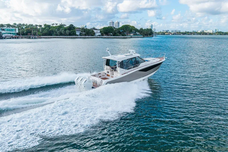 Slide: The Image of 2024 Boston Whaler 405 Conquest cruising on open water, showcasing sleek design and powerful engines. - 68