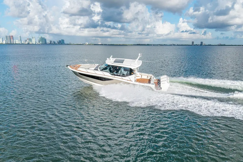 Slide: The Image of 2024 Boston Whaler 405 Conquest cruising on open water under a partly cloudy sky. - 72