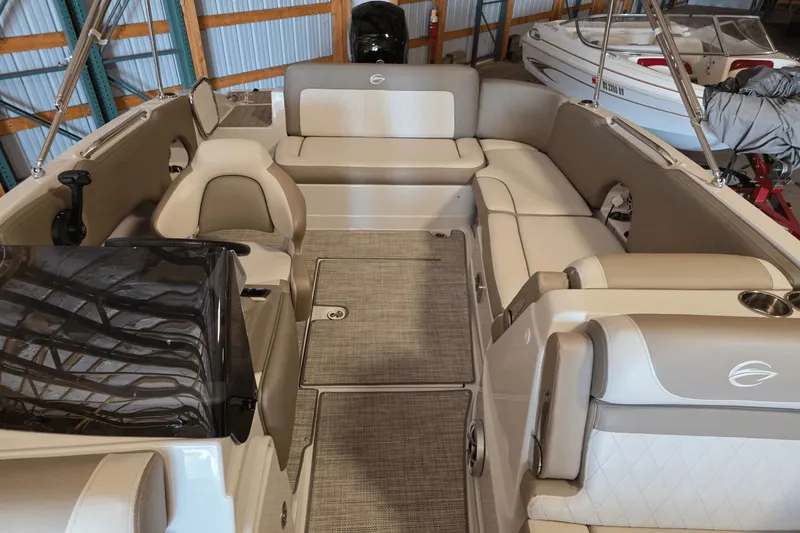 Slide: The Image of 2021 Crownline E 205 XS boat interior with beige seating and spacious layout. - 13