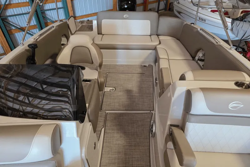 Slide: The Image of 2021 Crownline E 205 XS boat interior with beige seating and carpeted flooring. - 15