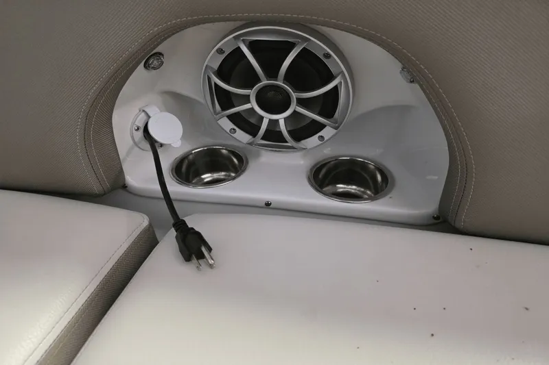 Slide: The Image of Interior of 2021 Crownline E 205 XS boat with speaker, cup holders, and power outlet. - 16
