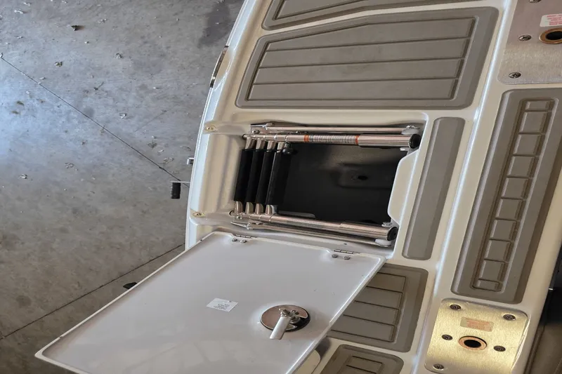 Slide: The Image of 2021 Crownline E 205 XS boat deck with open storage compartment. - 21