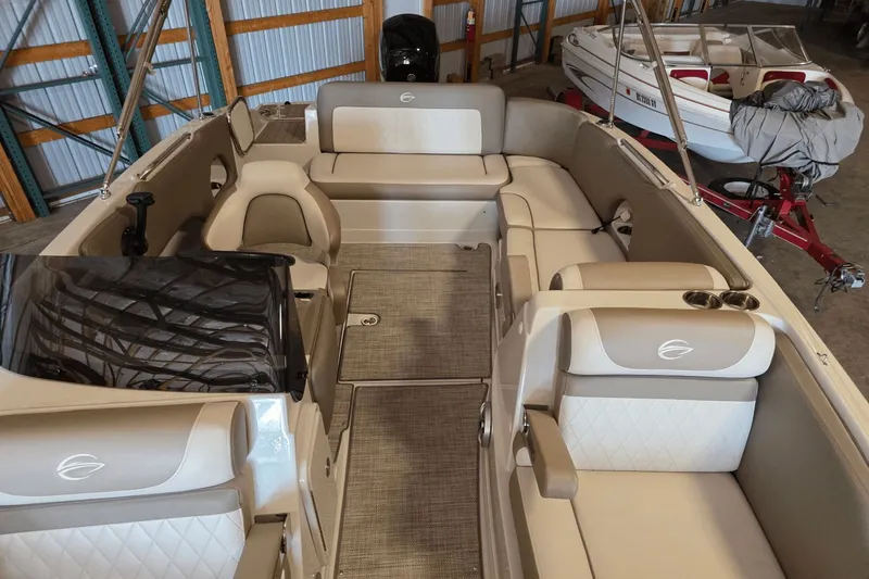 Slide: The Image of 2021 Crownline E 205 XS boat interior with beige seating and modern design. - 22