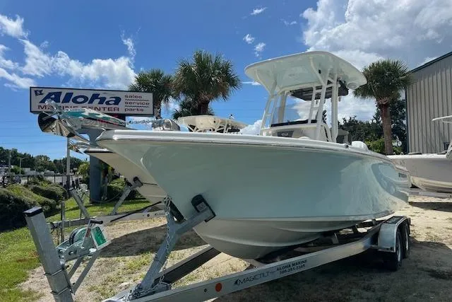 The Image of 2026 Key West 219 FS boat on trailer at Aloha Marine Center, sunny day. - 0