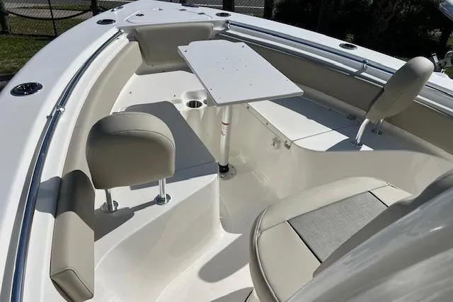 Slide: The Image of 2026 Key West 219 FS boat interior with seating and table setup. - 10