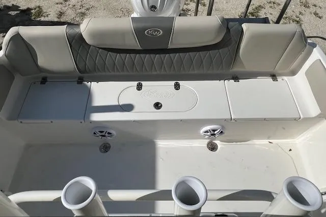 Slide: The Image of 2026 Key West 219 FS boat interior with cushioned seating and storage compartments. - 2
