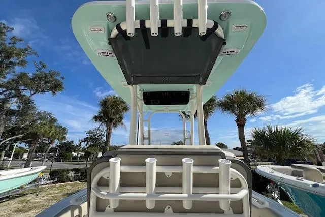 Slide: The Image of 2026 Key West 219 FS boat with rod holders, under a clear blue sky. - 3