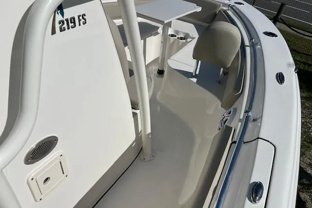 Slide: The Image of 2026 Key West 219 FS boat interior with seating and console details. - 7