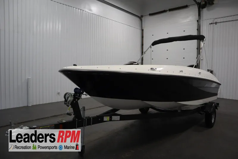 The Image of 2026 Bayliner Element E18 boat on trailer in indoor showroom. - 0